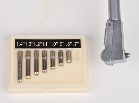 Dial bore gauge set with metal rods in a beige plastic case; measuring range 0.7-1.5 inches