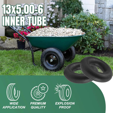 Two 13x5.00-6 Inner Tubes With Straight Valve Stem next to a wheelbarrow filled with stones on grass lawn.