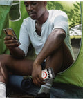 Man sitting in tent with Orienteering Compass Ruler Navigation Tool For Hiking And Camping With High Precision Dial And Luminous Coating