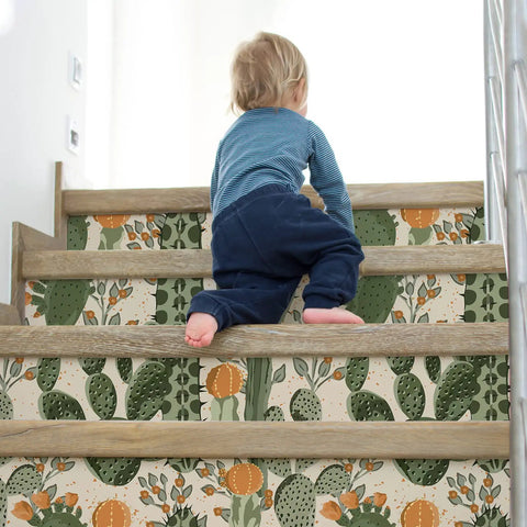 Child climbing stairs with Desert Cactus Wallpaper Peel And Stick Floral Cacti And Succulents Boho Wall Mural on risers.