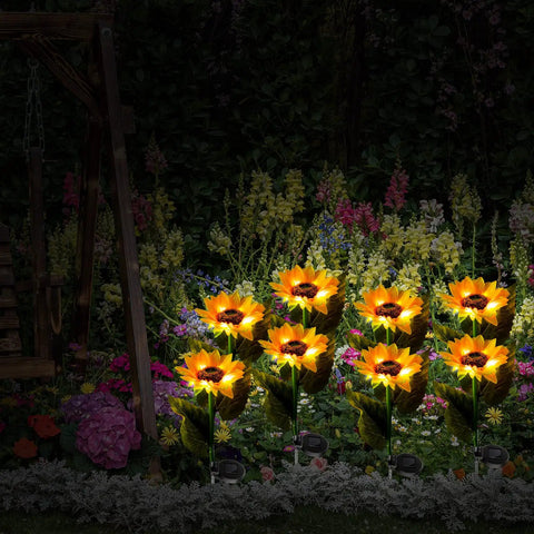 16 Pack Solar Sunflower Garden Lights Led Solar Powered Waterproof Stakes illuminating a garden pathway at night.