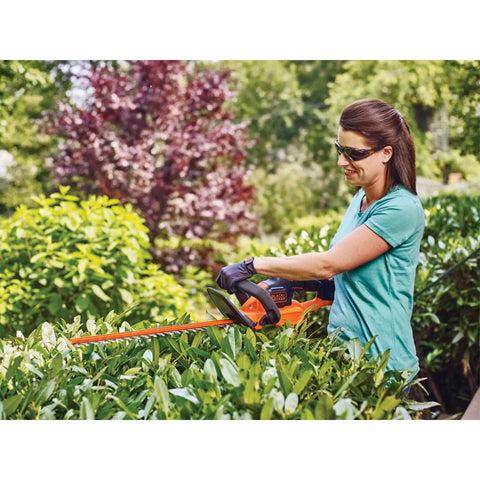 Woman using 40V MAX Cordless Hedge Trimmer With 24 Inch Dual Action Blade, No Cords Needed, Long Battery Life, outdoors