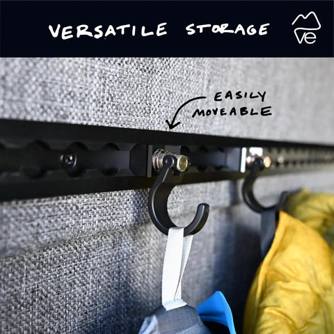 Spring Loaded L-Track Gear Hook Set, Adjustable Base, Heavy-Duty 100 lb Break Strength, 25 lb Working Load, Carbon Steel With Anodized T6 Aluminum Base, Black, Pack of 2, installed view on van wall showing versatile and movable storage with hooks holding gear.