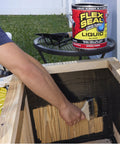 Person applying Liquid Rubber Sealant That You Can Brush, Roll, Dip Or Pour On For A Watertight Flexible Coating, 16 oz can nearby.