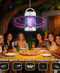 Portable USB Skeeter Zapper Lamp With 4000V Grid hanging over outdoor dining table with friends, blue UV light visible