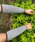 Cut Resistant Arm Sleeves With Level 5 Protection And 10 Inch Length For Work Breathable Anti Abrasion Safety Sleeves For Men And Women 3 Pairs Black And Gray Comfortable Arm Protectors For Tough Jobs being used in a garden setting