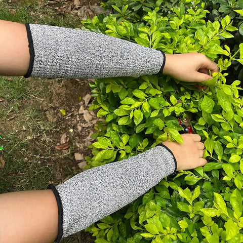 Cut Resistant Arm Sleeves With Level 5 Protection And 10 Inch Length For Work Breathable Anti Abrasion Safety Sleeves For Men And Women 3 Pairs Black And Gray Comfortable Arm Protectors For Tough Jobs being used in a garden setting