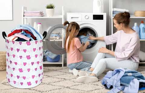 Round Laundry Basket Storage Bin For Home And Nursery, Super Lightweight Hamper With Cute Minimalist Vibe next to mother and daughter doing laundry