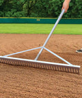 Person using Aluminum Landscape Rake Tool with 36 Inch Head and 69 Inch Lightweight Handle for lawn care