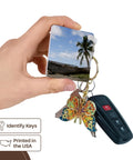 Outrigger Fishing Canoe Key Chain Set From Fiji Bright Multicolor Print Heavy Duty Plastic High Gloss Finish Dual Sided Image Includes Hardware 2 Pack held in hand