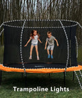 Trampoline with Solar Rope Lights Outdoor Waterproof 2 Pack 33ft 100 LED String Lights With 8 Modes in a garden setting