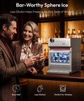 Elite Countertop Clear Ice Ball Maker Featuring Smart App Control And Reliable WiFi Connectivity Plus A Built In Twenty Four Hour Timer, couple enjoying whiskey with clear ice spheres.