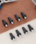Heavy Duty Cabinet Door Repair Pins 8 Piece Kit Spring Loaded Hinge Dampers on a brown surface, showcasing black snap-in furniture hardware.
