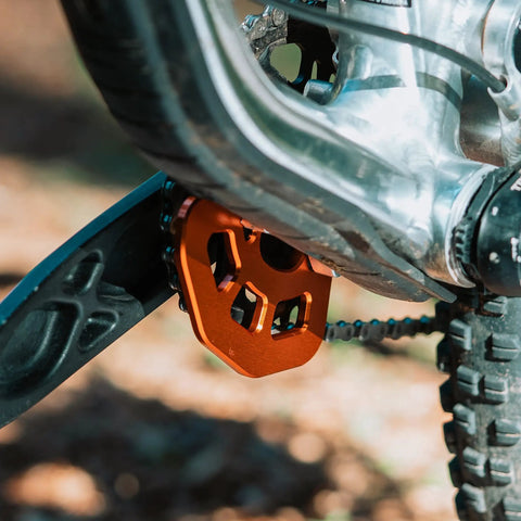 FortiGuard Alloy MTB Bash Guard ISCG05 Compatible For 26T To 36T Chainrings Protects Your Mountain Bike Chainring On Off Road Rides BMX Black Durable Alloy Construction showing side view of orange guard mounted on bike