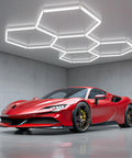 Hexagon LED Garage Lights 6500K Ultra Bright 156W 17280LM Beast Mode Daylight Honeycomb Panels For Garage Workshop Basement Gym Barber Shop White 5 Grid Hex Light Fixture installed on ceiling with red sports car below in a garage.