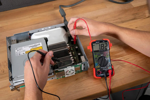 Auto-Ranging Digital Multimeter For Automotive And Home Electrical Troubleshooting UL Certified in use on circuit board
