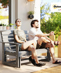 Two Person Outdoor Glider Bench For Backyards And Patios In Weather Resistant HDPE Distressed Gray with couple seated