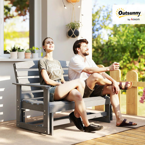 Two Person Outdoor Glider Bench For Backyards And Patios In Weather Resistant HDPE Distressed Gray with couple seated