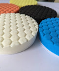 Badass 6-Inch Foam Buffing Pads for Cars in various colors, showcasing a textured foam surface for detailing.