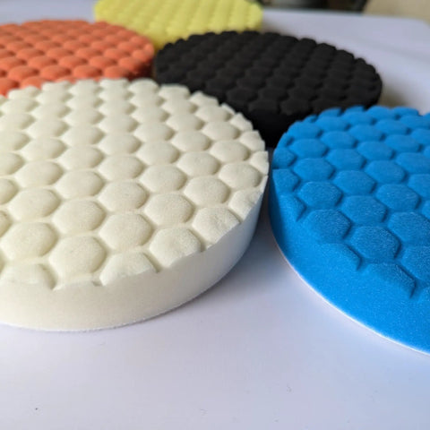 Badass 6-Inch Foam Buffing Pads for Cars in various colors, showcasing a textured foam surface for detailing.