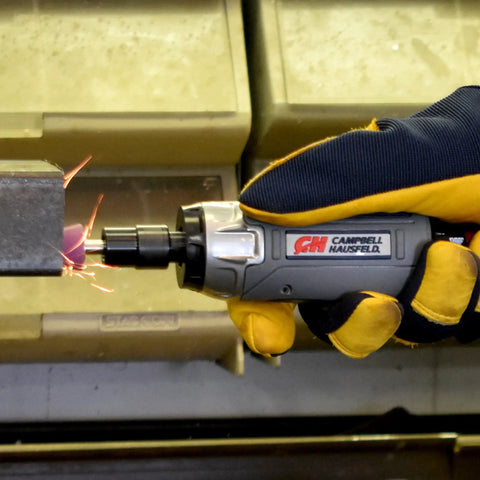 Tough As Nails Straight Pneumatic Die Grinder delivers 25000 RPM, held in a gloved hand, polishing metal with sparks flying.
