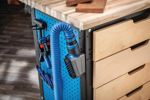 Dust Right Click-Connect Bench Brush And Dock Kit attached to FlexiPort hose on woodworking bench with pegboard.