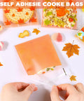 Fall Treat Bags 200 Pack, 4x4 Self Sealing Cellophane Bags with autumn leaves design being sealed, perfect for candy and snacks