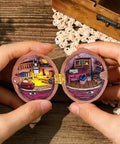 Hands holding an open miniature wooden room with a 100 Piece Tiny Dollhouse Hinges Set With 180 Degree Mini Metal Hinge Hardware.