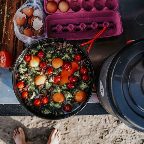 10-Inch Nonstick Fry Pan For Camping And Backpacking Stoves, filled with eggs, tomatoes, and broccoli, on a camp table