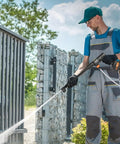 Man using Cordless Pressure Washer 652 PSI 1 GPM Brushless Motor Rechargeable 4Ah Battery Powered Handheld Washer Gun on gate