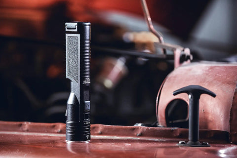 Stinger High Output LED Duty Flashlight With Piggyback Charging Kit 2000 Lumen 25000 Candela on industrial surface.