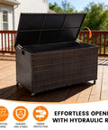 Boss Grade 170 Gallon Outdoor Deck Box Crafted From Durable Wicker Rattan With Smooth Roll Wheels open with hydraulic rod on patio.