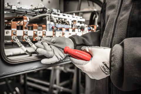 Person using SwissGrip Slotted And Phillips Screwdriver Kit With Click Fastened 215 Blades on electrical panel Bordeaux.