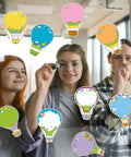 Hot Air Balloon Sticky Notes Bulk Pack, 36 Packs In 9 Styles, 2.9 X 3.9 Inch displayed by smiling students in classroom