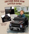 Child in black Ford F-150 Raptor Licensed 12V Ride On Truck For Kids With Parent Remote, LED lights, 3-point seat belt.