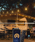 48 Feet LED Outdoor String Lights With App And Remote Control Dimmable Waterproof Patio Lighting illuminating RV awning at night