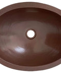 Top view of 16 By 13 Inch Oval Skirted Vessel Copper Sink Hand Hammered Pure Copper Brown Finish For Modern Bath Semi Recessed Vessel One And A Half Inch Drain Opening Eighteen Gauge Handmade In Mexico CPS10