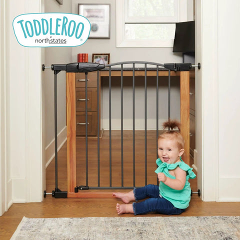 Woodgrain Steel Baby Gate With Auto Close For Doorways, Adjustable From 29.75 To 40.5 Inches Wide And 30 Inches Tall, shown in hallway with child
