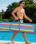 Man carrying Blue Oxford Mesh Pool Noodle Storage Bag With Zipper Grab And Go Portable Swim Toy Organizer by the pool.