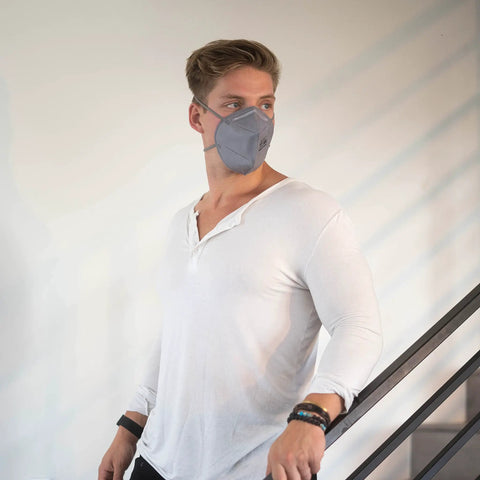 Man wearing gray N95 Disposable Respirator Mask Made In USA Super Comfy Fit Breathable Skin Friendly Nonwoven Fabric NIOSH Approved