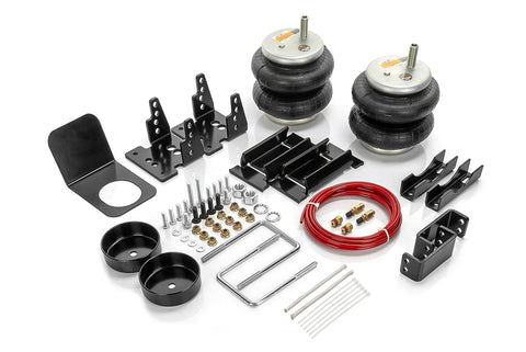 TORQUE airbag suspension kit with two rubber air springs, black steel brackets, red air hose, and mounting hardware.