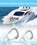 Close-up of two stainless steel marine carabiner snap hooks in foreground with a yacht at sea in the background