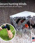 30 Pack Tent Stakes 9 Inch Galvanized Steel Ground Spikes securing a snow-covered hunting blind