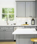 Modern kitchen with grey cabinets featuring Matte Black Round Cabinet Knobs 25 Pack, 1-1/4 Inch Drawer Pulls for Kitchen Cabinets.