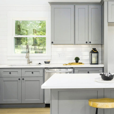 Modern kitchen with grey cabinets featuring Matte Black Round Cabinet Knobs 25 Pack, 1-1/4 Inch Drawer Pulls for Kitchen Cabinets.