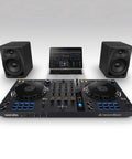 DJ setup with laptop, DJ controller, and DM 50D BT 5 Inch Desktop Monitor System With Bluetooth For DJs And Beat Makers Dual 2 Way Sound Modes