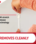 Hand removing Medium Wire Toggle Hooks Set With 7 Wall Hooks And 8 Adhesive Strips for damage-free hanging using 3M technology