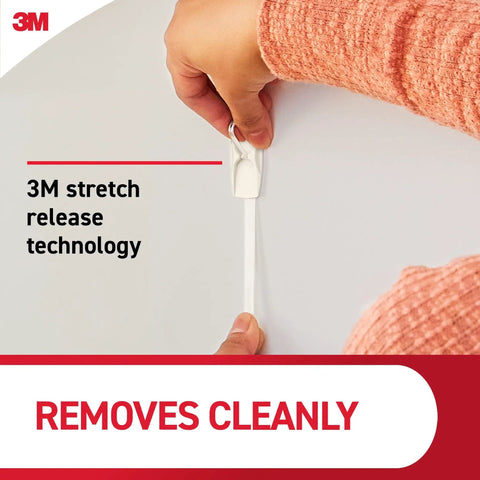 Hand removing Medium Wire Toggle Hooks Set With 7 Wall Hooks And 8 Adhesive Strips for damage-free hanging using 3M technology