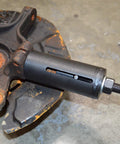 Astro Tools 78620A ball joint puller remover, side view of black tool installed in a rusted wheel hub.