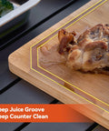 Juicy cooked meat on bamboo cutting board with deep juice groove, part of 5 In 1 Grill Prep Tray And Carry System For Outdoor Barbecues.
